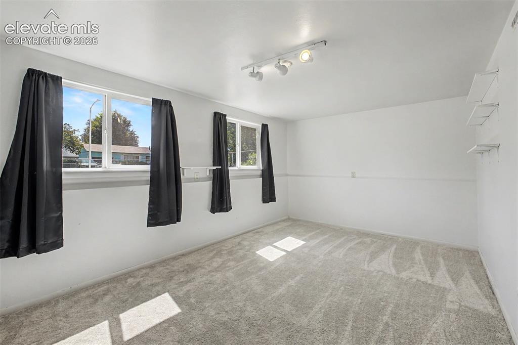 Image 14 of 37: Lower level room offers lots of flexibility as a recreation room, office or