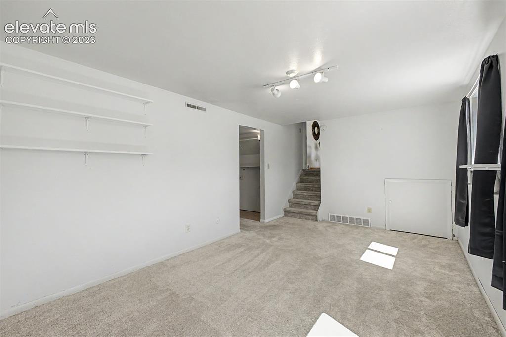 Image 15 of 37: Lower level room offers lots of flexibility as a recreation room, office or