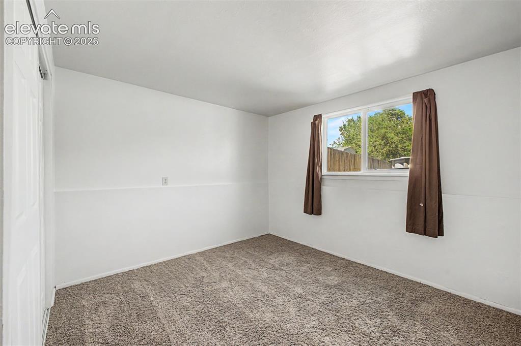 Image 18 of 37: Lower level bedroom makes for a perfect office or guest room. 