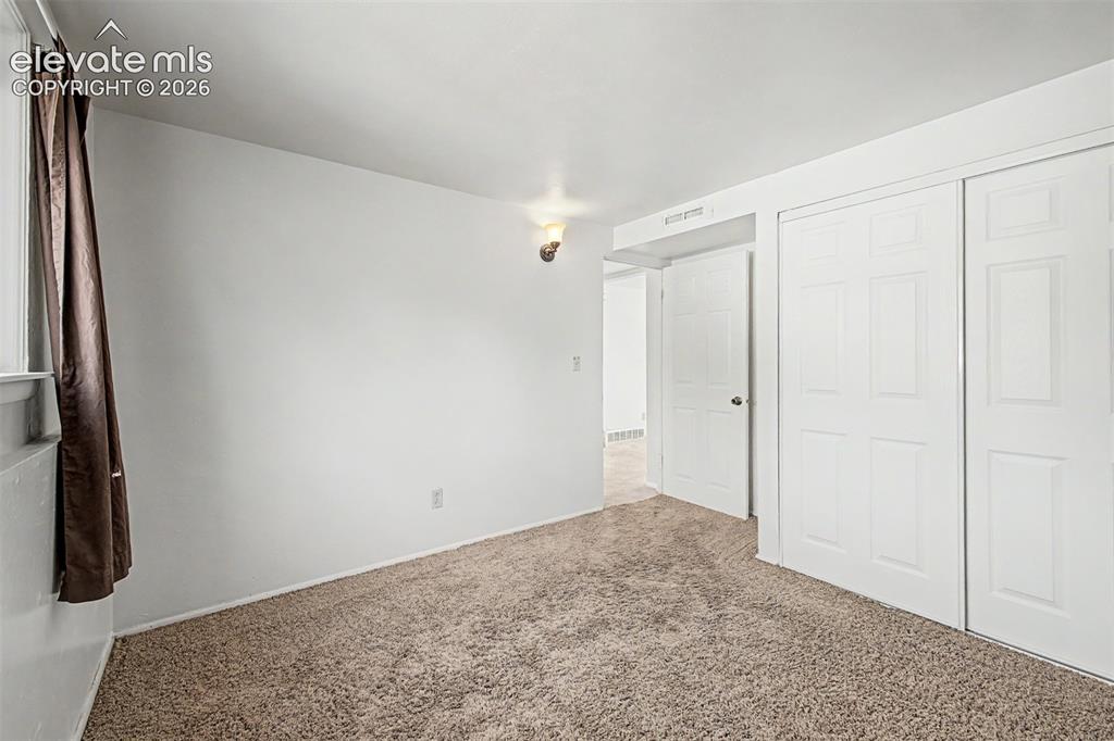 Image 19 of 37: Lower level bedroom makes for a perfect office or guest room.