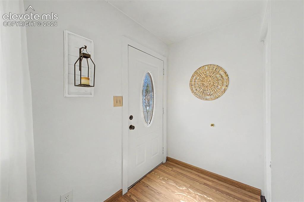 Image 20 of 37: White entry door with decorative glass insert welcome you home