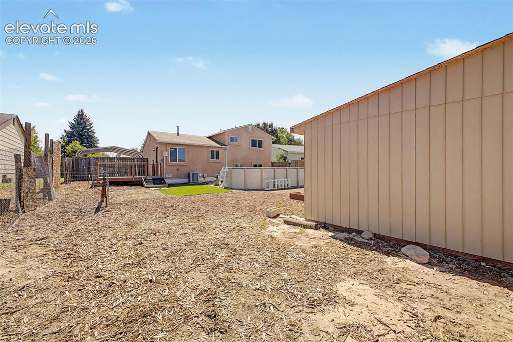 Image 24 of 37: Expansive yard offers plenty of options for recreation, garden space or eve