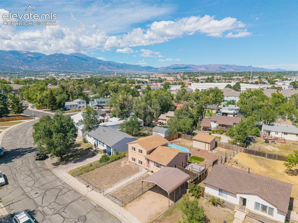 Image 31 of 37: Spacious lot featuring a detached carport, fenced yard, and an above-ground