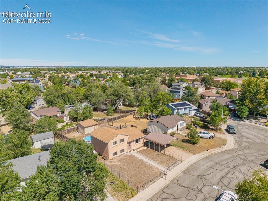 Image 32 of 37: Spacious lot featuring a detached carport, fenced yard, and an above-ground