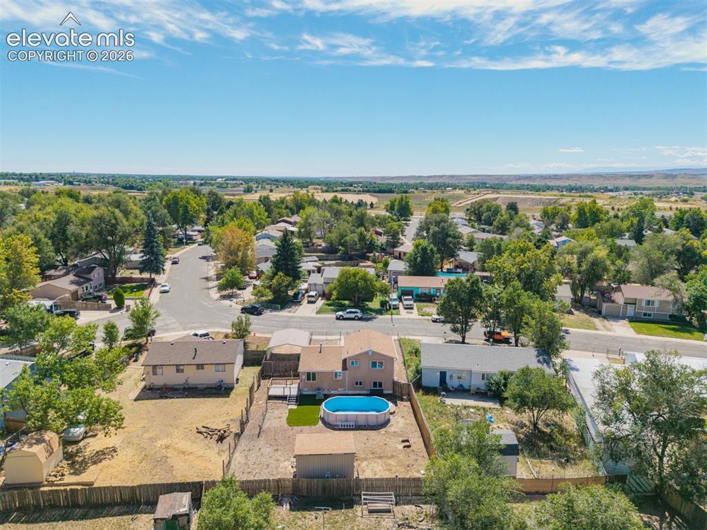 Image 33 of 37: Spacious lot featuring a detached carport, fenced yard, and an above-ground