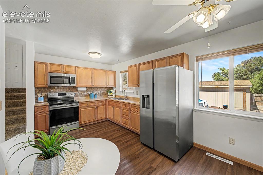 Image 6 of 37: Kitchen with updated cabinets, newerr stainless steel appliances, and a mos