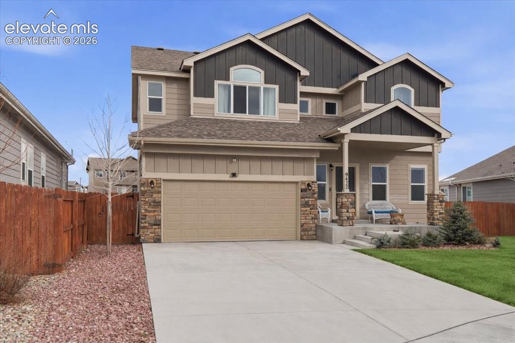Image 1 of 31: Two-story exterior with a covered front porch, stone column accents, a two-