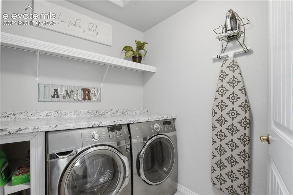 Image 13 of 31: White shelving, gray wall paint, and a built-in countertop with a light-col