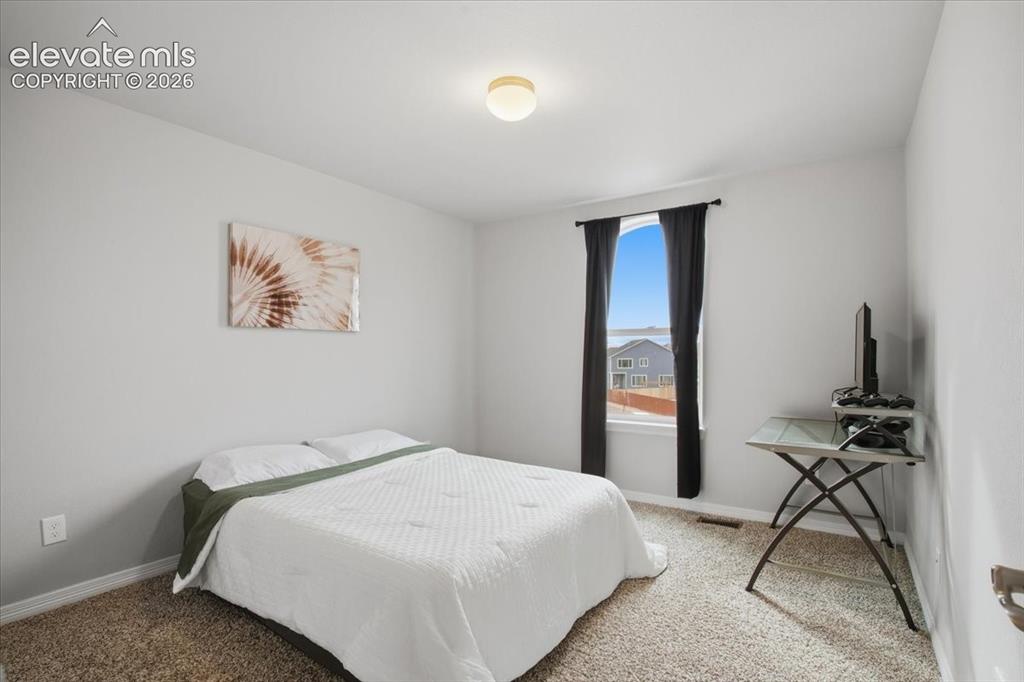 Image 19 of 31: Recessed window with black drapery, neutral wall paint, and overhead lighti