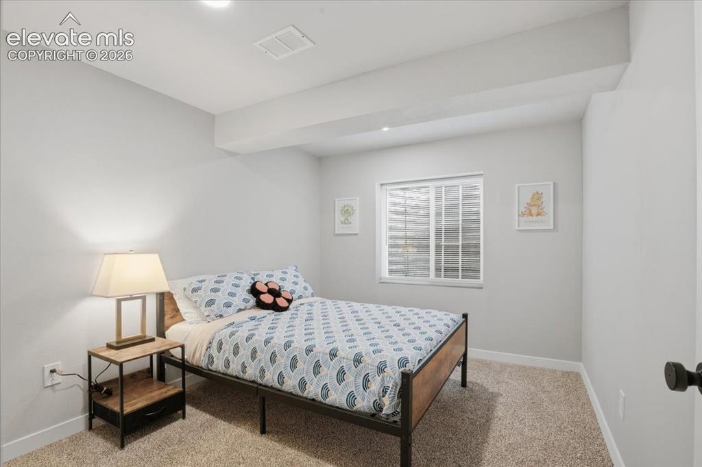 Image 22 of 31: Recessed lighting, light gray wall paint, white trim, textured carpet floor