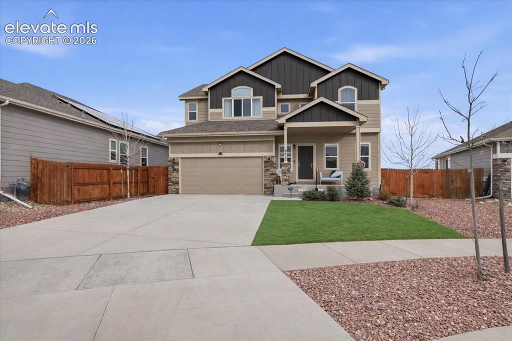 Image 30 of 31: Two-story residence featuring a covered front porch, an attached two-car ga