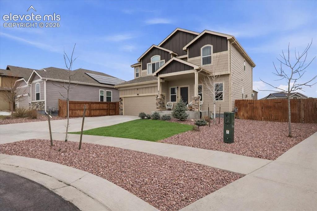 Image 31 of 31: Two-story residence featuring a covered front porch, attached two-car garag