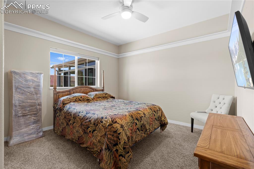 Image 14 of 45: Carpeted bedroom featuring baseboards and a ceiling fan