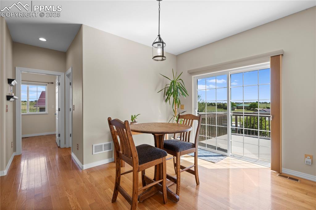 Image 17 of 45: apartment dining area and walk out to deck