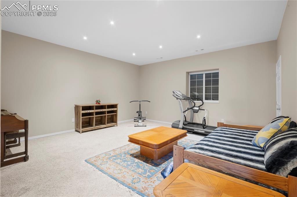 Image 22 of 45: Living area with carpet and recessed lighting