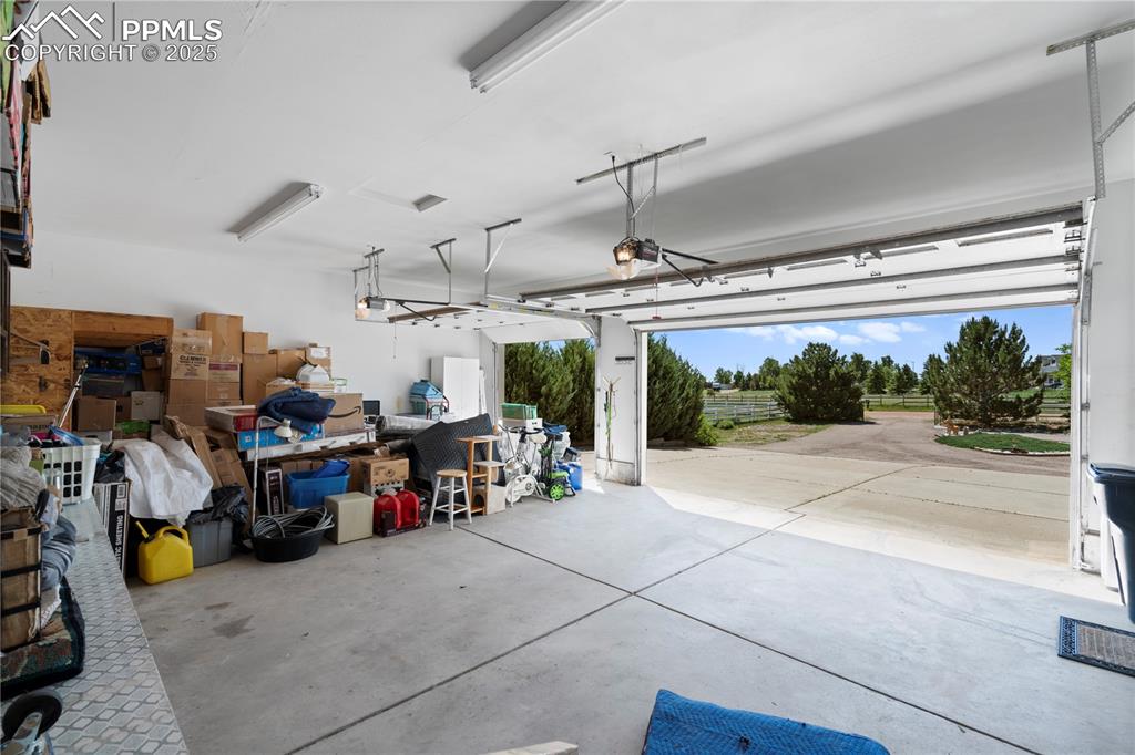 Image 23 of 45: Garage featuring a garage door opener