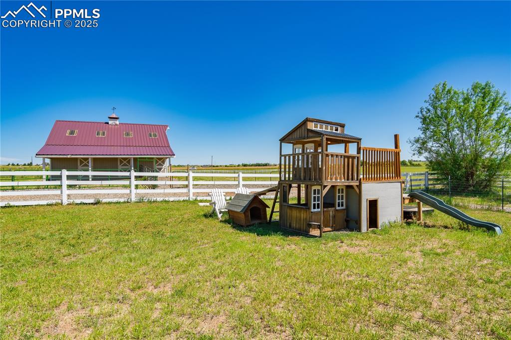 Image 31 of 45: View of yard with a playground and a water view