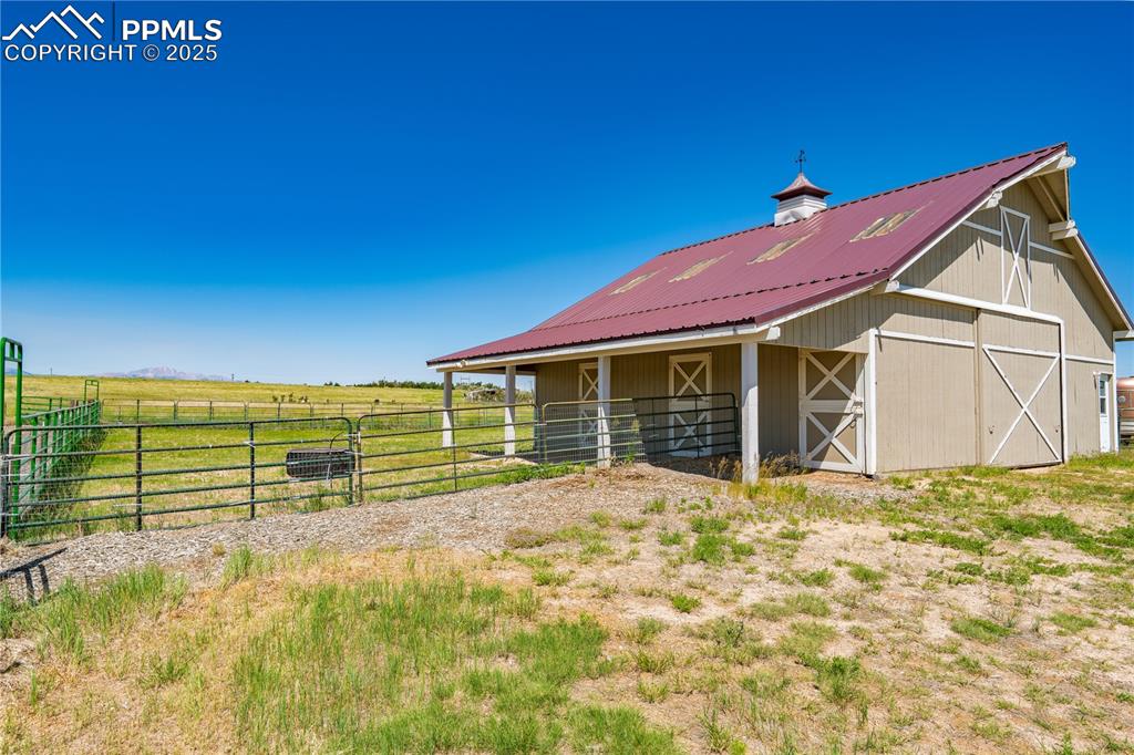 Image 34 of 45: View of barn featuring an exterior structure and a rural view