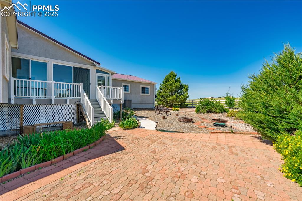Image 4 of 45: View of patio featuring stairs and a fire pit