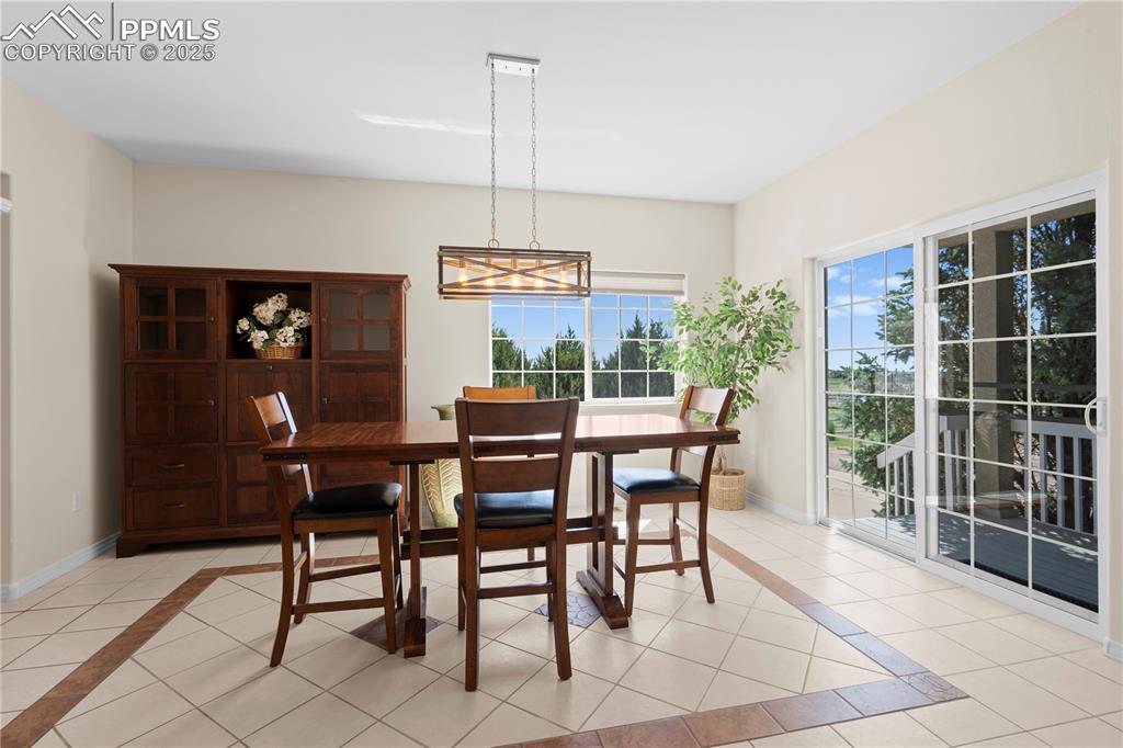 Image 8 of 45: Dining space with light tile patterned floors, a chandelier, and inlaid flo