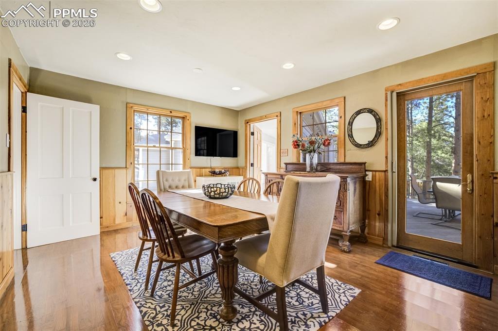 Image 10 of 50: Dining room, with lovely wainscoting, walkout to back deck