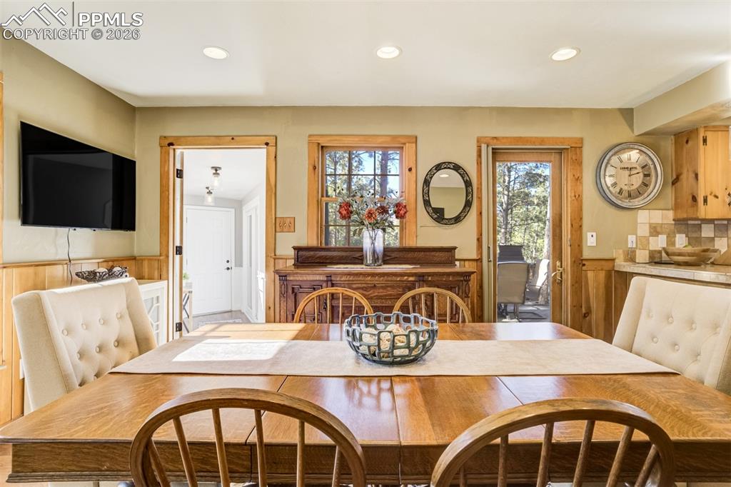 Image 11 of 50: Dining room, with lovely wainscoting, walkout to back deck