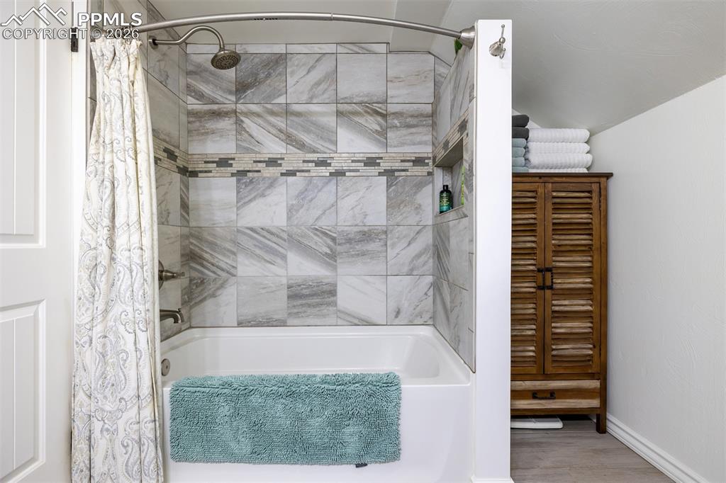 Image 29 of 50: Updated upstairs bathroom with tub shower combination