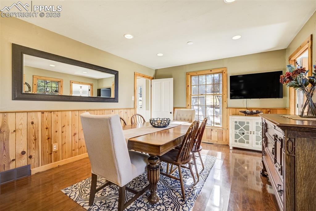 Image 9 of 50: Dining room, with lovely wainscoting, walkout to back deck