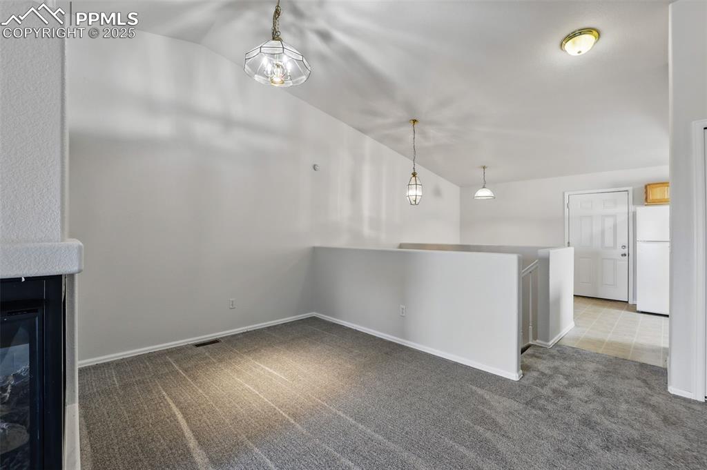 Image 13 of 50: Formal dining area with vaulted ceiling
