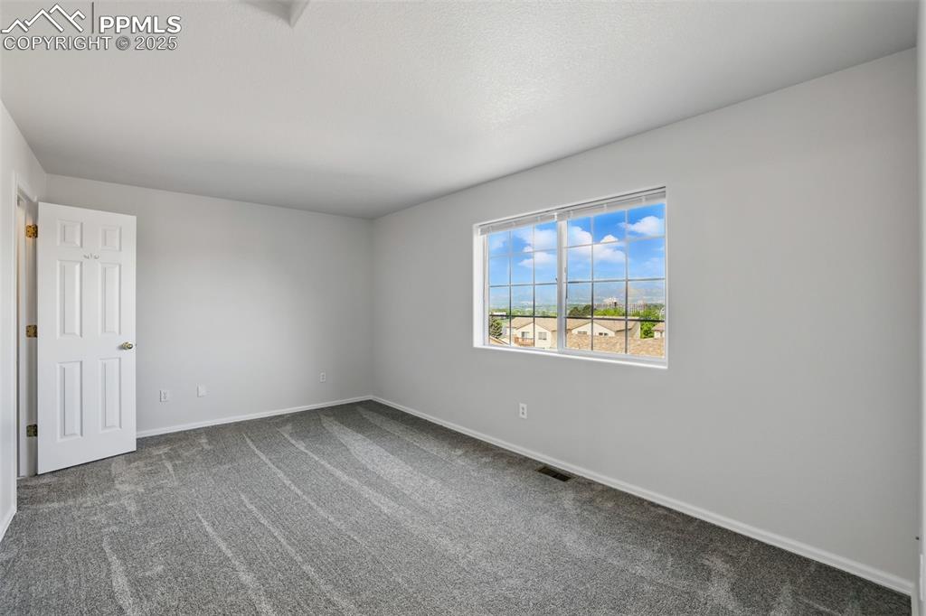 Image 21 of 50: Master bedroom with mountain views