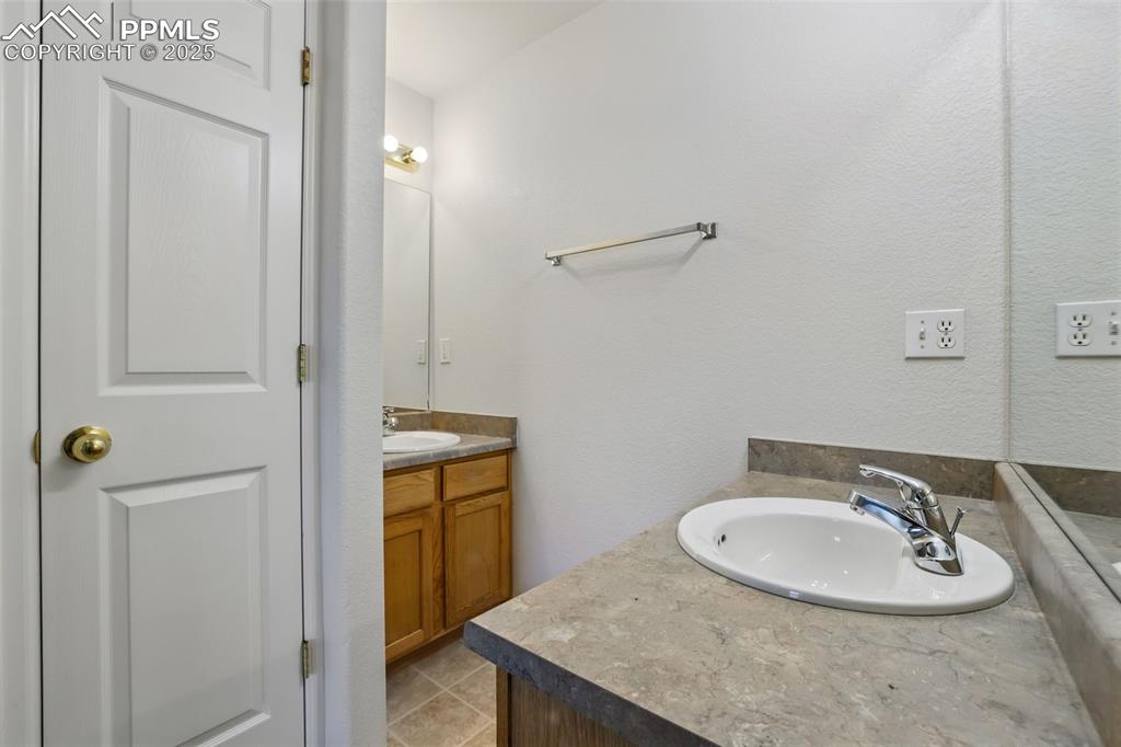 Image 28 of 50: Master bathroom with dual vanity & linen closet