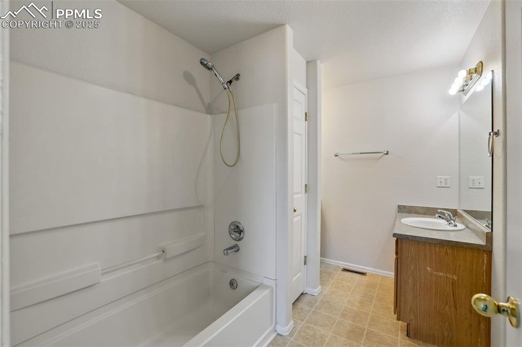 Image 29 of 50: 5 Piece master bathroom featuring dual vanity, shower/bath combination line