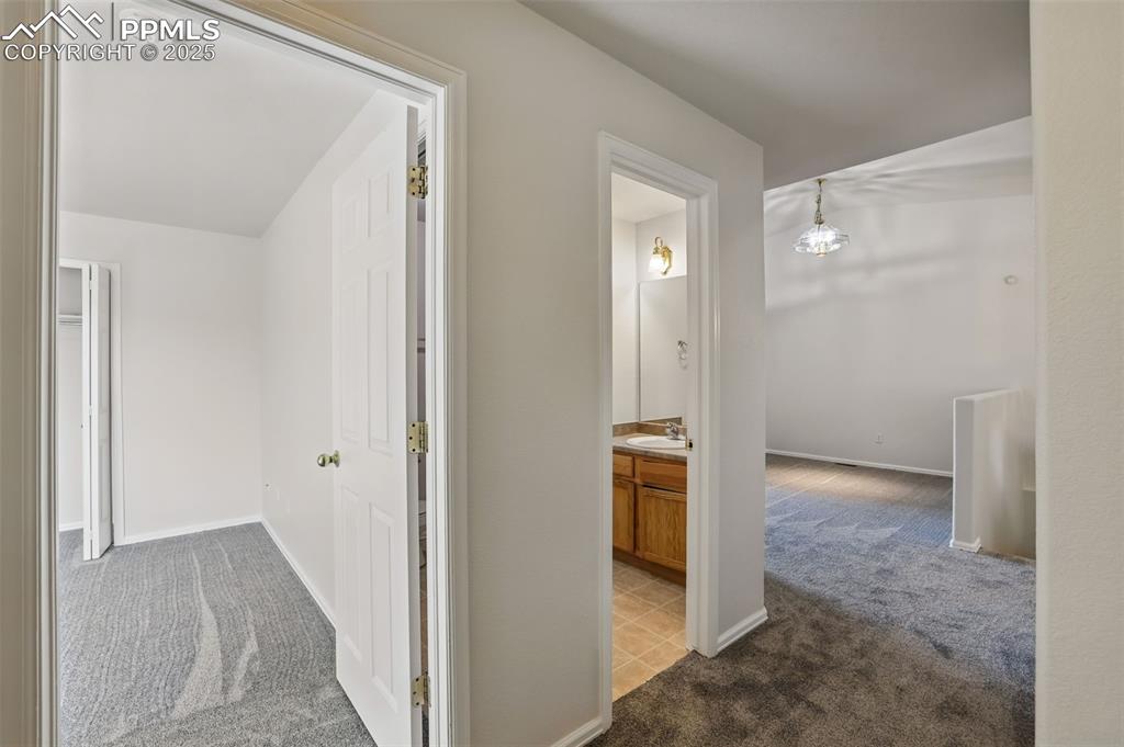 Image 31 of 50: Front front entry to bedroom 2, bathroom 2 and hall to formal dining room