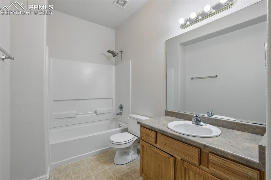 Image 44 of 50: Bathroom 3 with a linen closet, large vanity, shower/bathtub combination