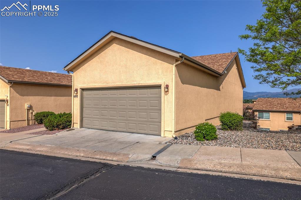 Image 5 of 50: View of front of property featuring an attached 2 car garage, stucco siding