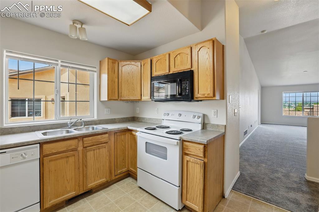 Image 9 of 50: Kitchen with white appliances