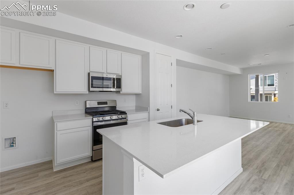 Image 10 of 37: Kitchen includes gas range, built-in microwave and dishwasher