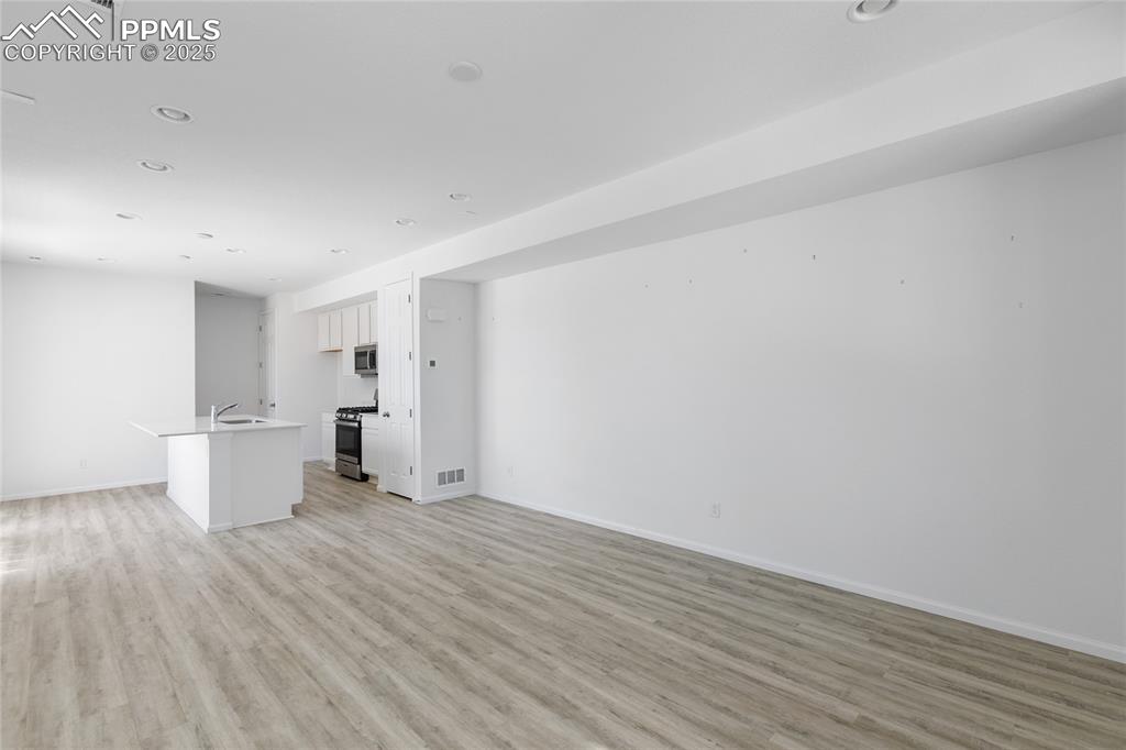 Image 7 of 37: Open living room/kitchen area