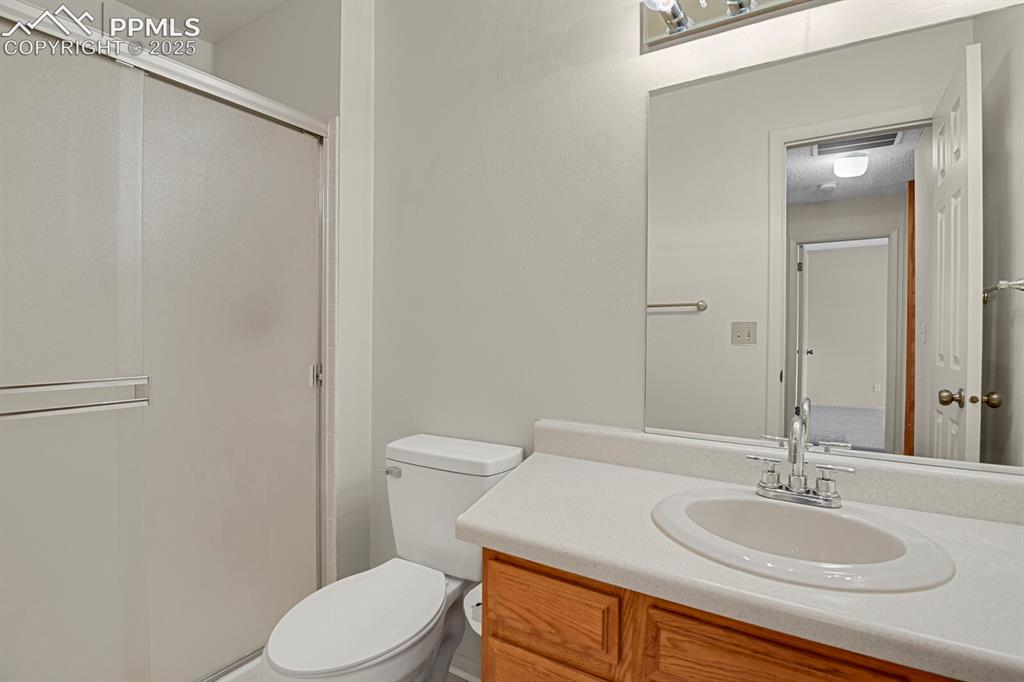 Image 17 of 23: Full bathroom with a stall shower and vanity