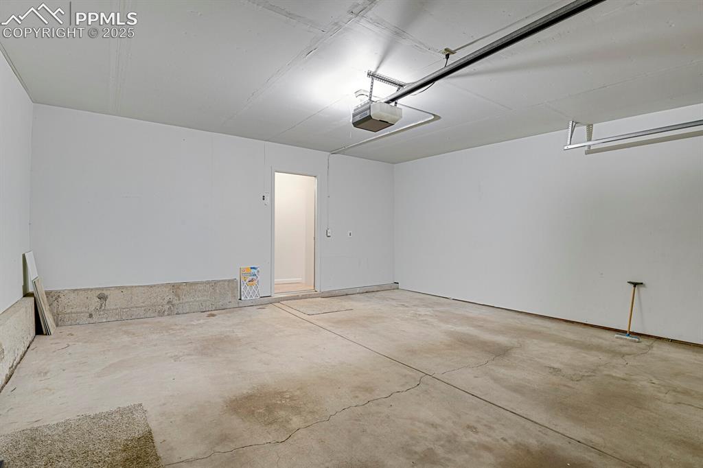 Image 19 of 23: Garage featuring a garage door opener