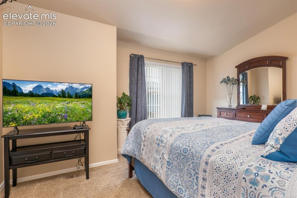 Image 11 of 18: Upper level primary bedroom.