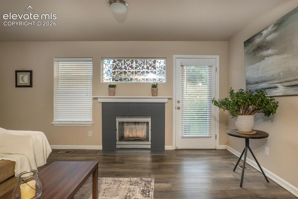 Image 7 of 18: The living room is off of the kitchen. Gas fireplace for the upcoming winte