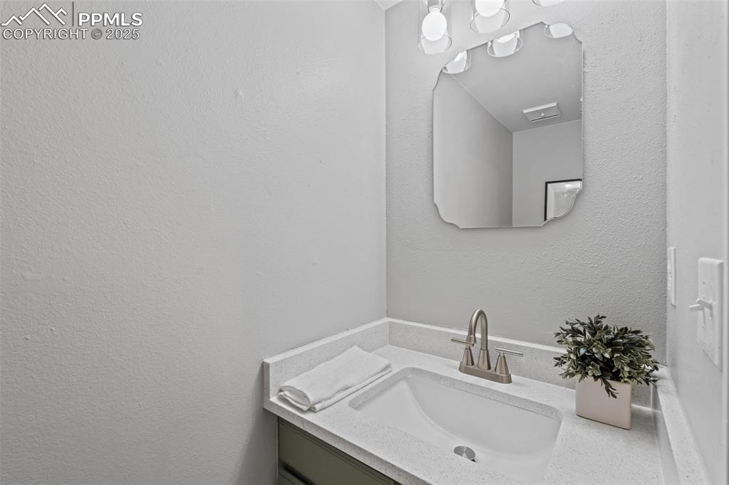 Image 10 of 40: Bathroom featuring a textured wall and vanity