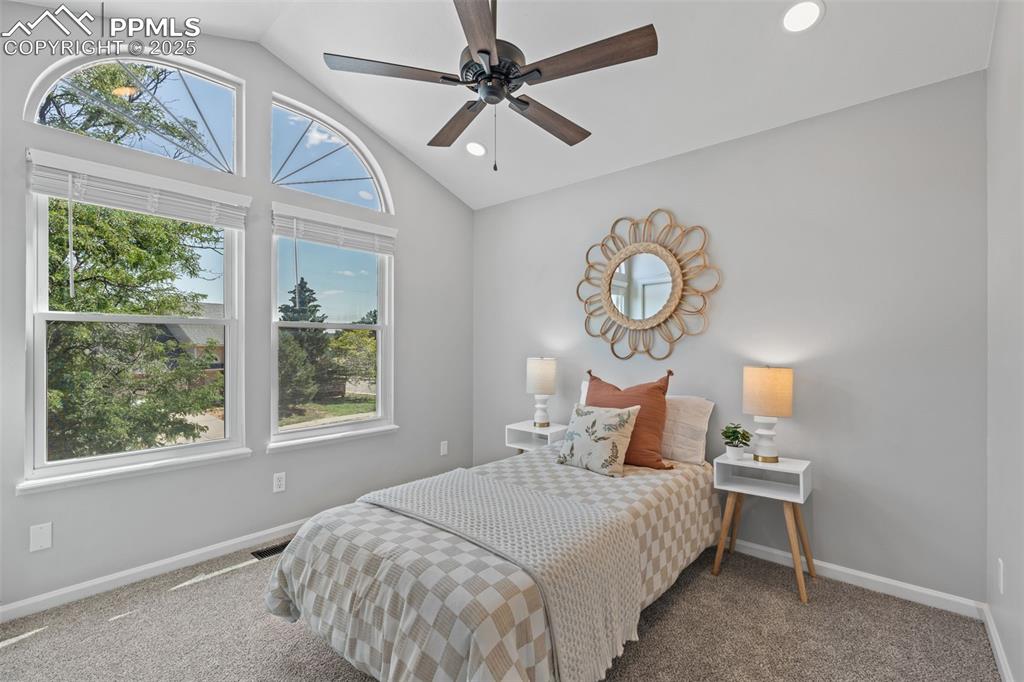 Image 25 of 40: Bedroom with lofted ceiling, carpet, a ceiling fan, and recessed lighting
