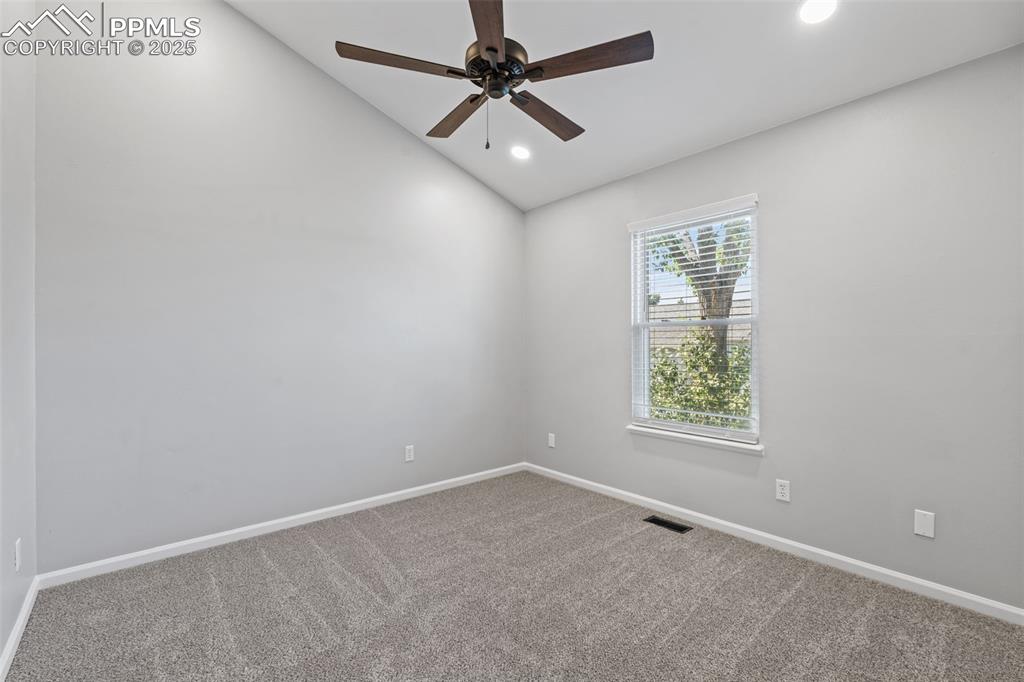 Image 28 of 40: Carpeted empty room with vaulted ceiling, recessed lighting, and a ceiling 