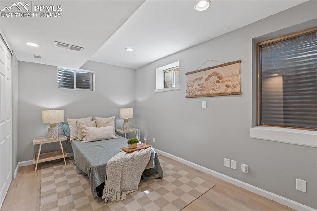 Image 30 of 40: Bedroom featuring light wood finished floors and recessed lighting