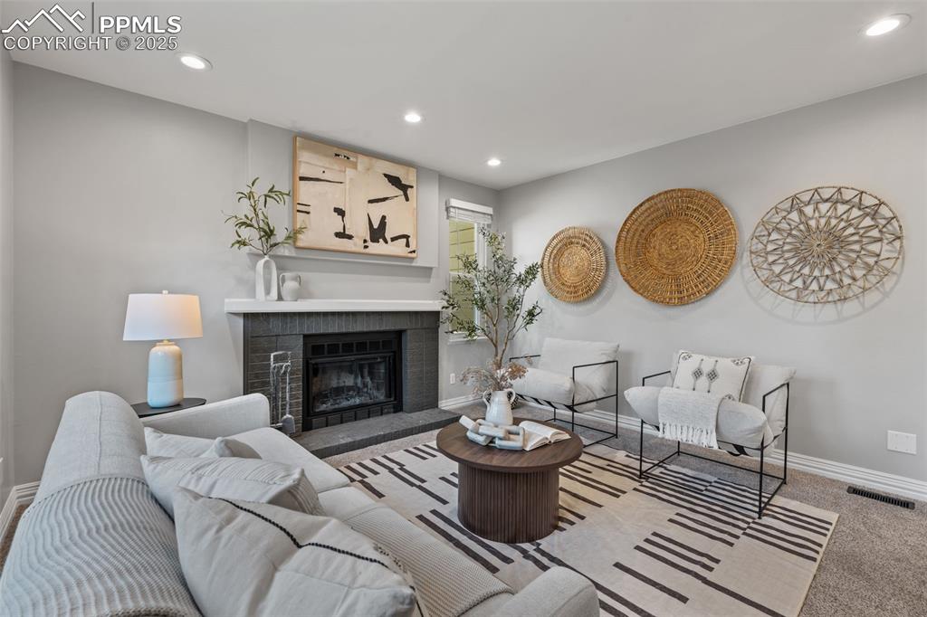 Image 7 of 40: Carpeted living room featuring recessed lighting and a fireplace