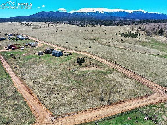 Image 3 of 4: Birds eye view of property with a rural view and a mountain view