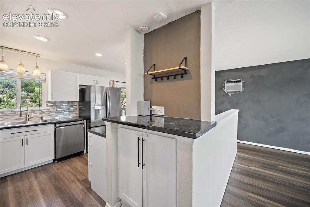 Image 11 of 50: Kitchen with white cabinetry