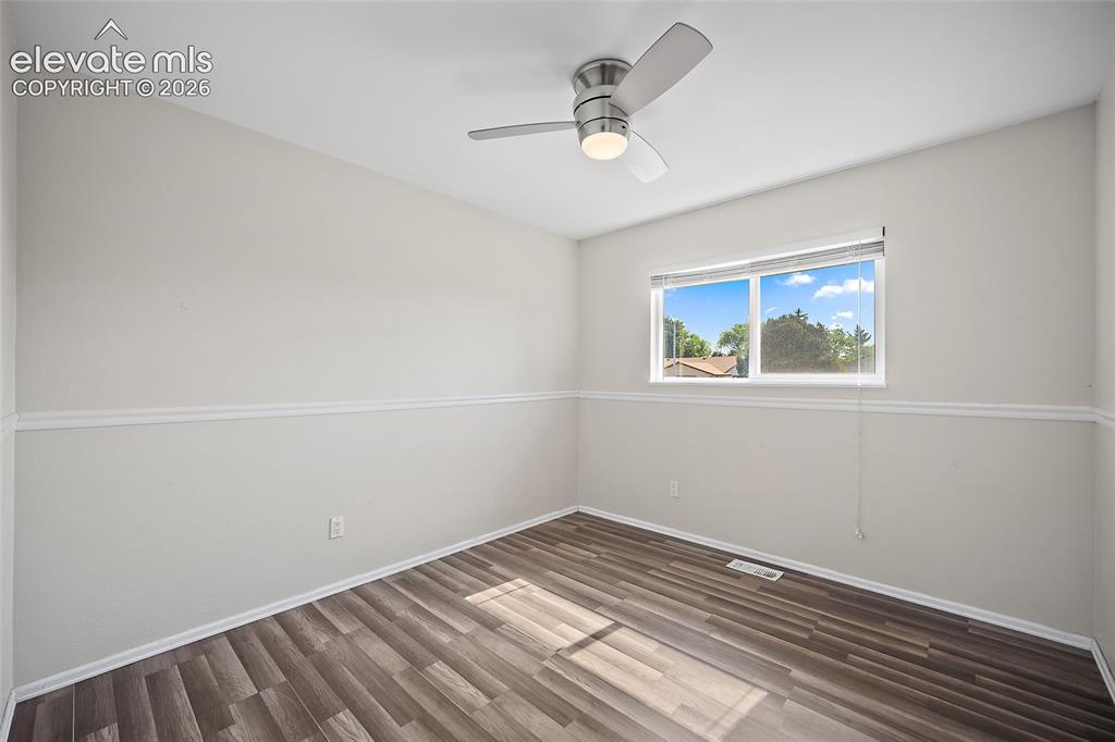 Image 18 of 50: Bedroom with views of mature trees.